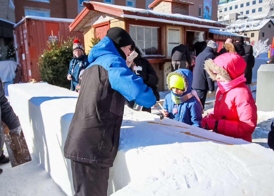 Quebec-Winter-Carnival-Taffy-in-the-snow-pouring