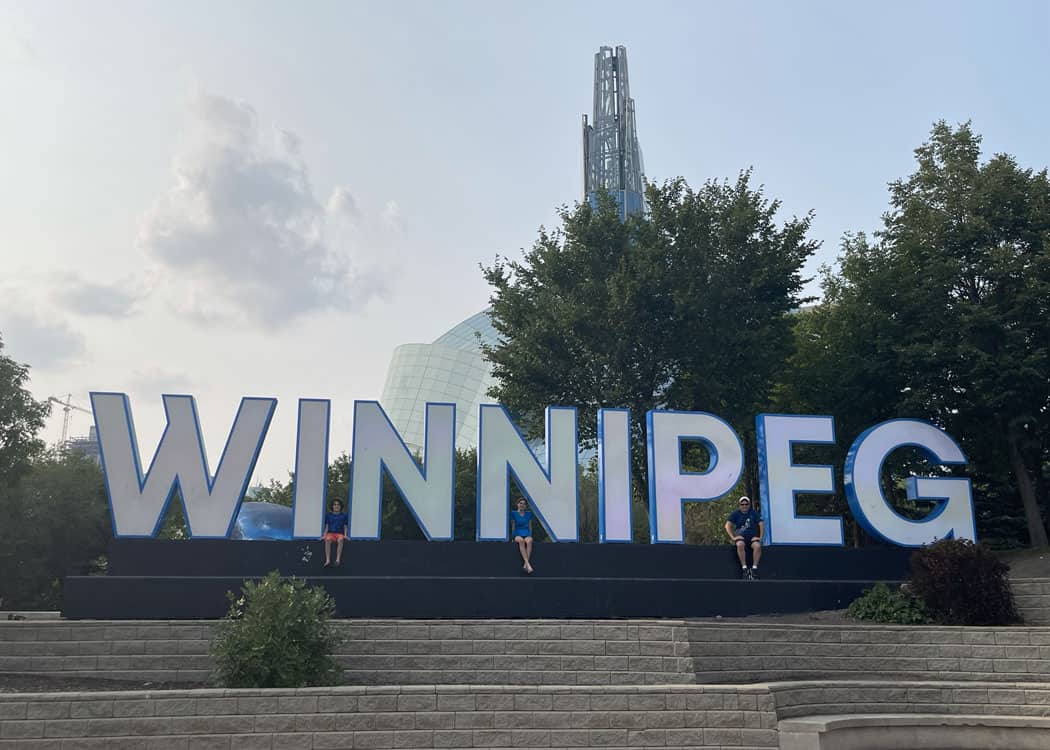 Winnipeg-family-with-sign