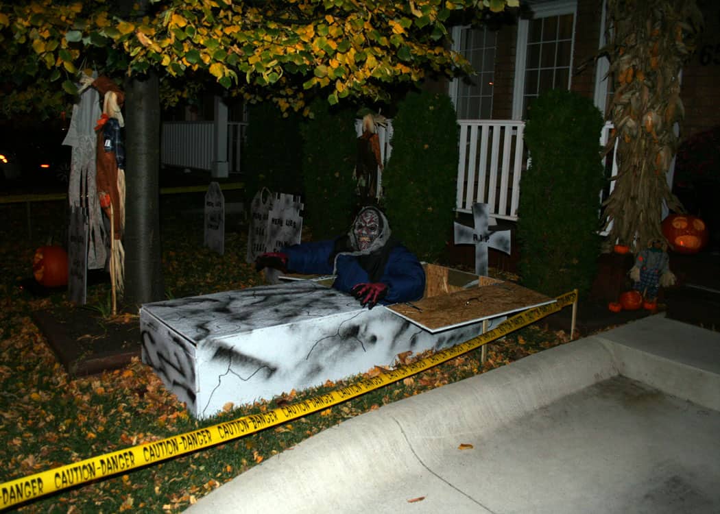 Lawn cemetery with ghoul coming out of coffin