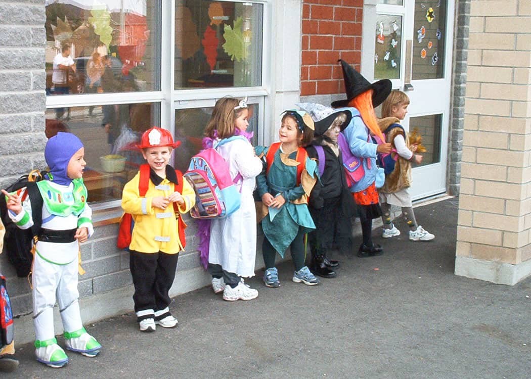 Little kids lined up at school in costume