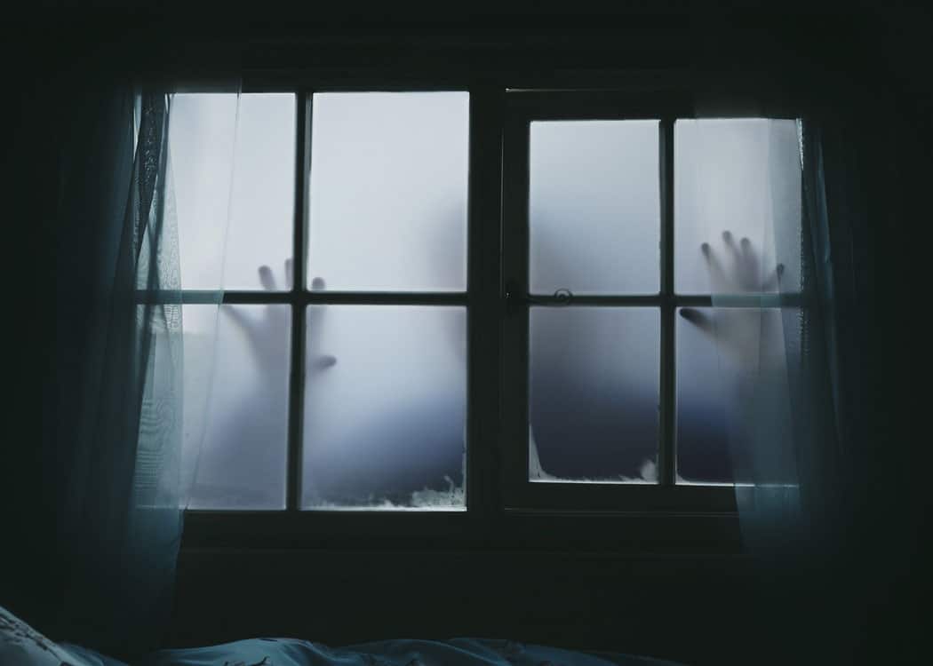 spooky window with hands touching glass