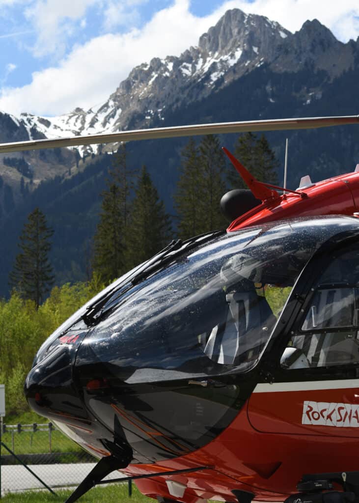 red-heli-on-the-ground-with-mountains