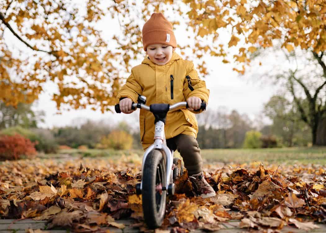 Toronto-in-Fall-Child-on-bicycle-in-fall-leaves