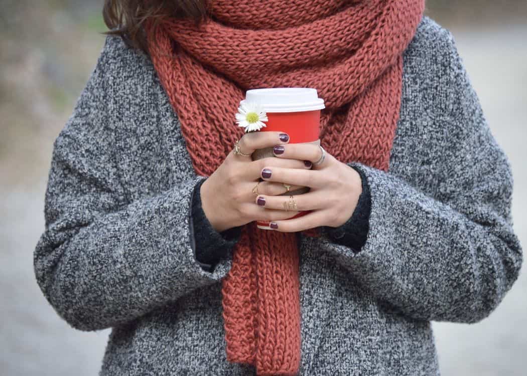 Toronto-in-Fall-Someone-wearing-Fall-Sweater-and-scarf-and-holding-a-coffee